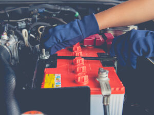 Mechanic inspecting car battery